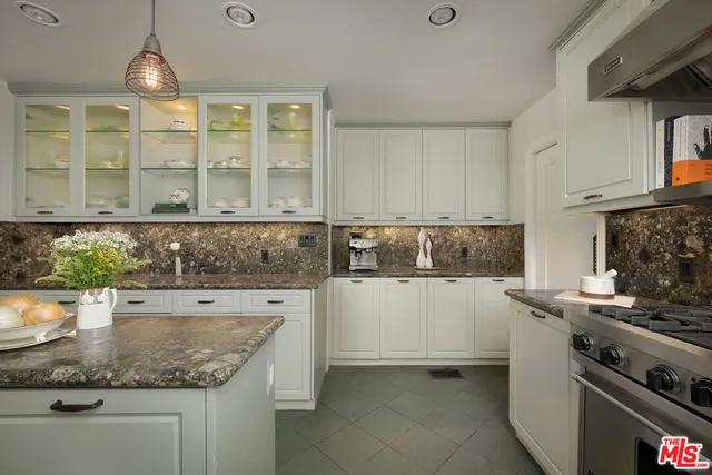 a living room with furniture a wooden floor and next to a window