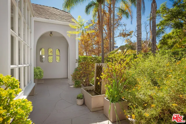 a dining room with furniture wooden floor a glass table and a fireplace