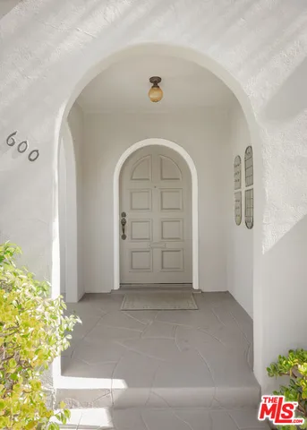 a living room with furniture a fireplace and a table