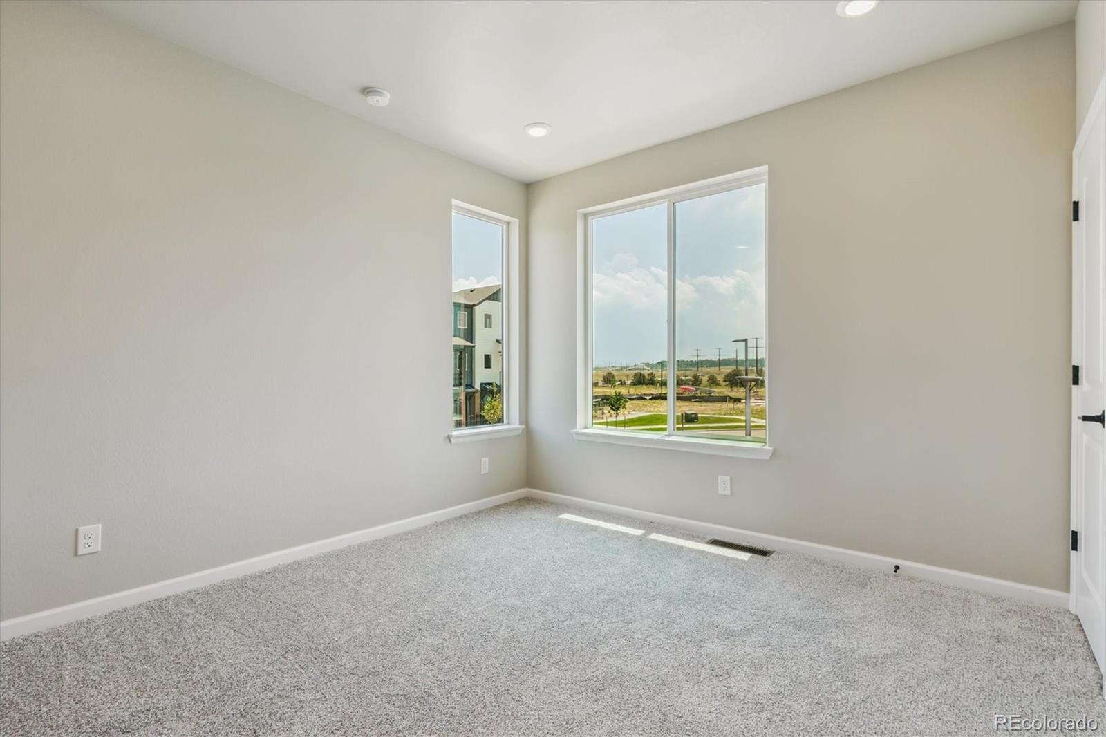 6720 Merseyside Lane Castle Pines, CO 80108 - Photo 11 of 24 an empty room with windows