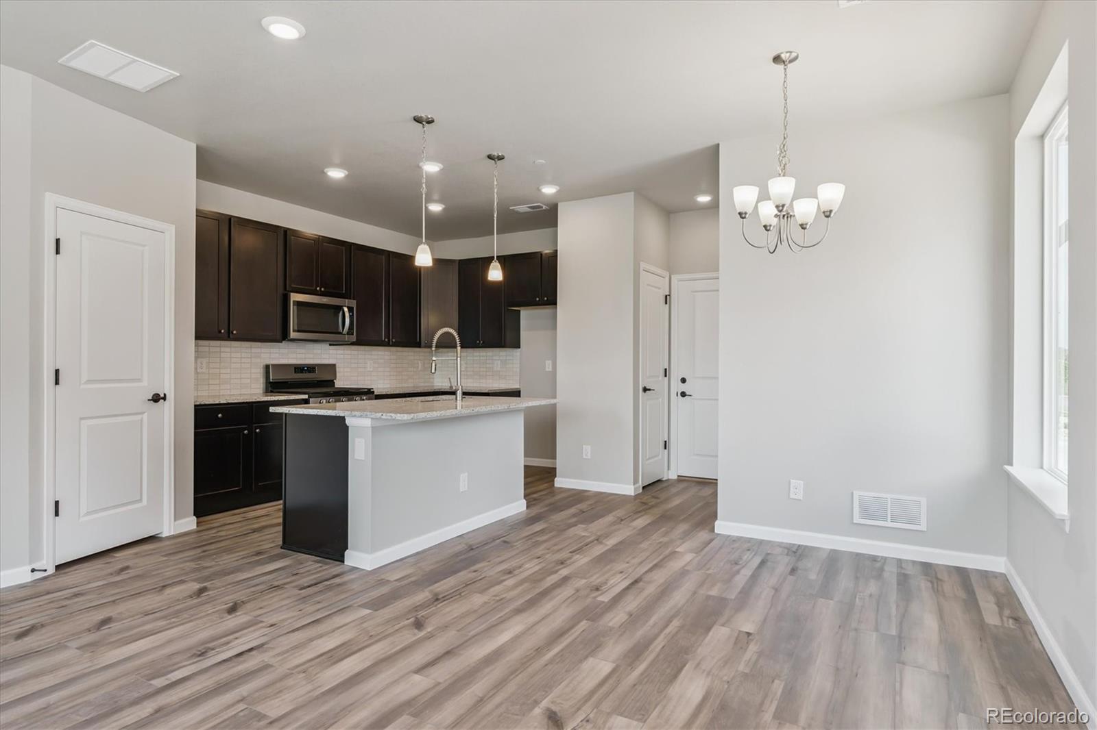 6720 Merseyside Lane Castle Pines, CO 80108 - Photo 2 of 24 a view of kitchen with granite countertop cabinets and refrigerator
