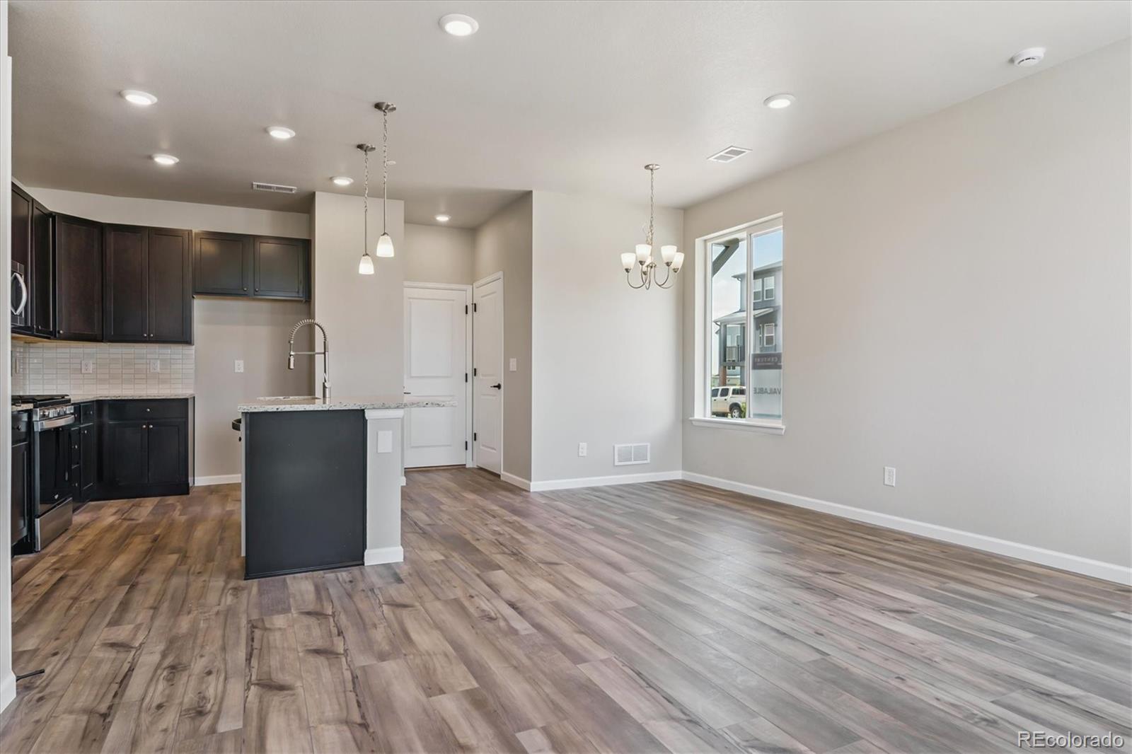 6720 Merseyside Lane Castle Pines, CO 80108 - Photo 5 of 24 a view of kitchen with cabinets and wooden floor
