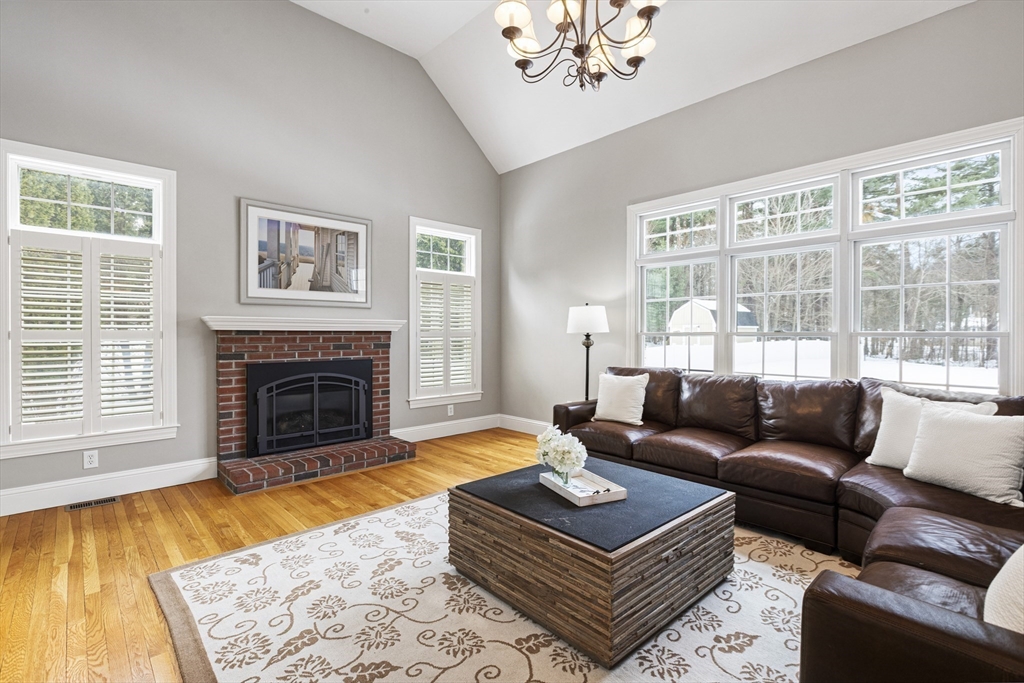 5 Apple Rock Road Millis, MA 02054 - Photo 16 of 42 a living room with furniture a rug and a fireplace