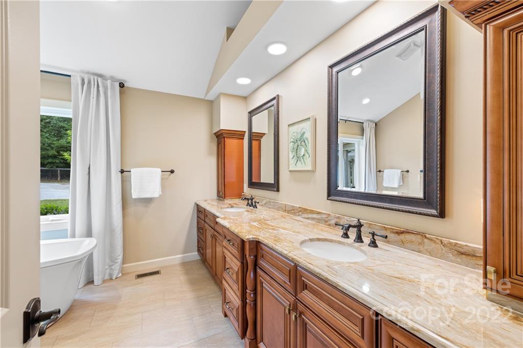 1040 Landrum Mill Road Campobello, SC 29322 - Photo 15 of 39 a bathroom with a granite countertop sink and a mirror