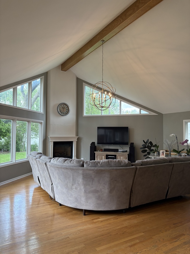 609 West Gartner Road Naperville, IL 60540 - Photo 3 of 23 a living room with fireplace furniture and a flat screen tv