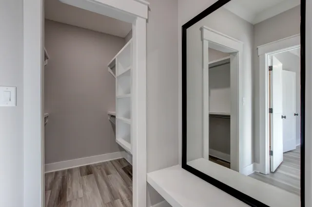 a view of walk in closet with empty racks