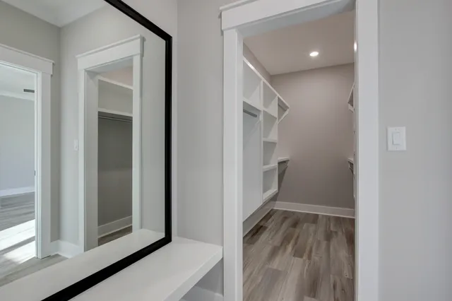 a view of walk in closet with empty racks