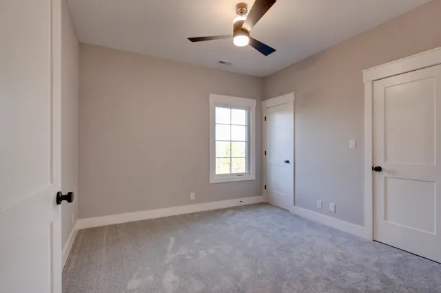 a bathroom with a sink a toilet a mirror and shower
