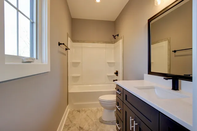 a view of a livingroom with a window and a ceiling fan