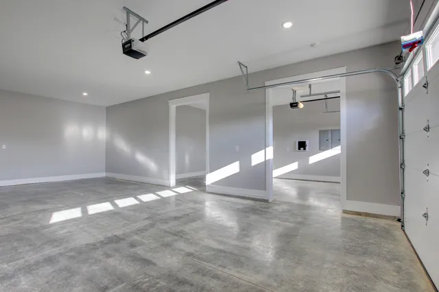 a view of a big room with wooden floor and windows