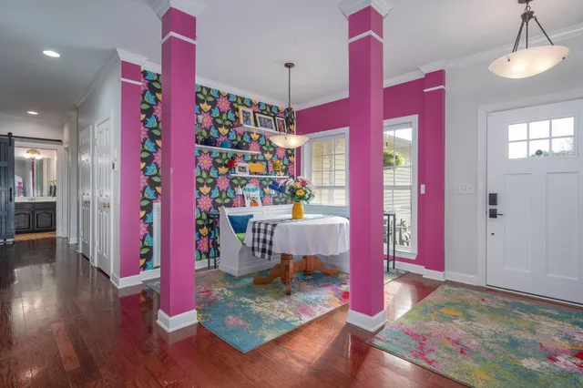 a very nice looking room with a large window and wooden floor