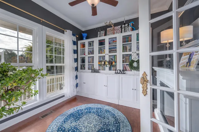 a bedroom with a bed a chandelier and potted plant