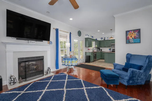 a living room with furniture a flat screen tv and a fireplace