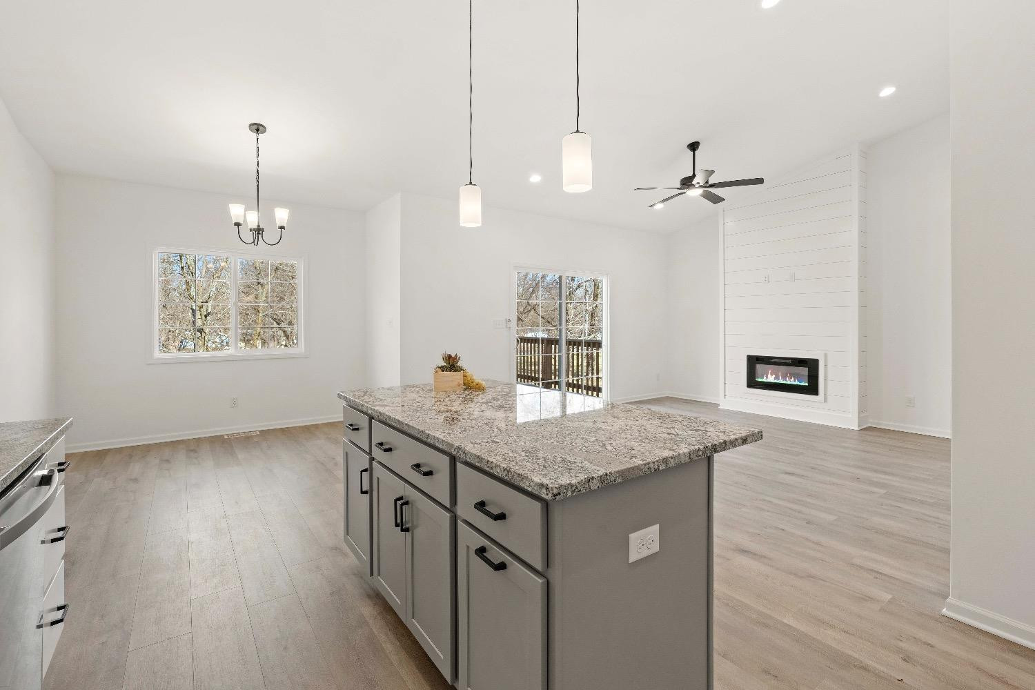 1036 Hwy 330 Griffith In 46319 Griffith, IN 46319 - Photo 7 of 27 a kitchen with a wooden floor and a chandelier