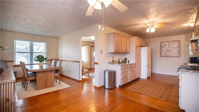 a large kitchen with cabinets wooden floor and stainless steel appliances