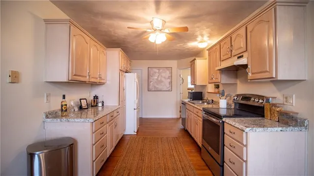 a kitchen with stainless steel appliances granite countertop a stove and a refrigerator