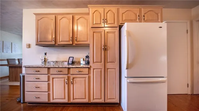 a kitchen with stainless steel appliances granite countertop a refrigerator and a stove