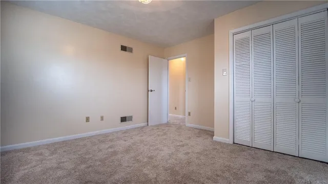 a view of an empty room with closet area