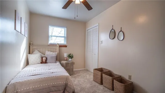 a bedroom with a bed and ceiling fan