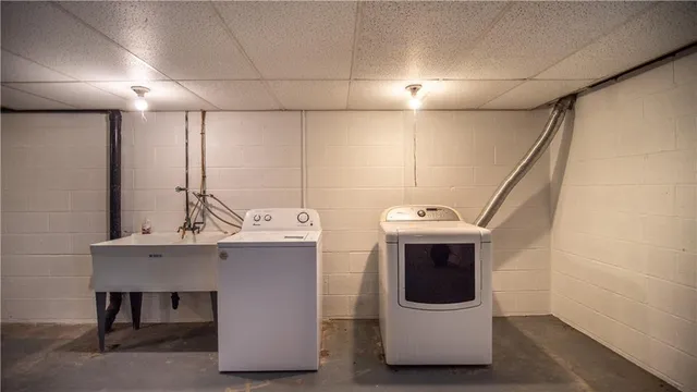 a utility room with wooden floor and sink