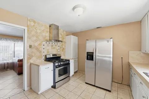 a kitchen with stainless steel appliances granite countertop a stove and a refrigerator