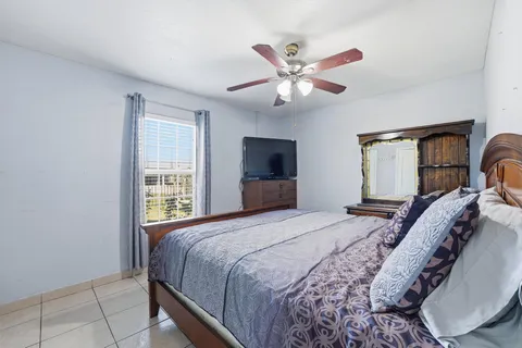 a bedroom with a large bed and a chandelier
