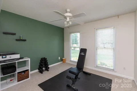 a view of a workspace with furniture and a window