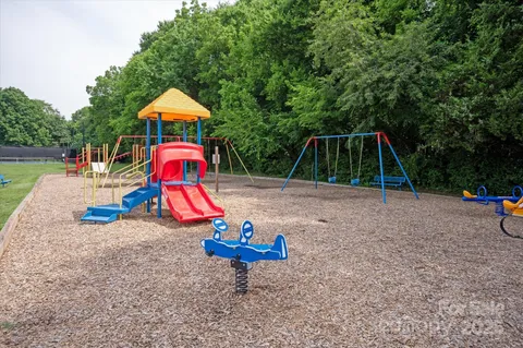a view of playground with a slide and swing