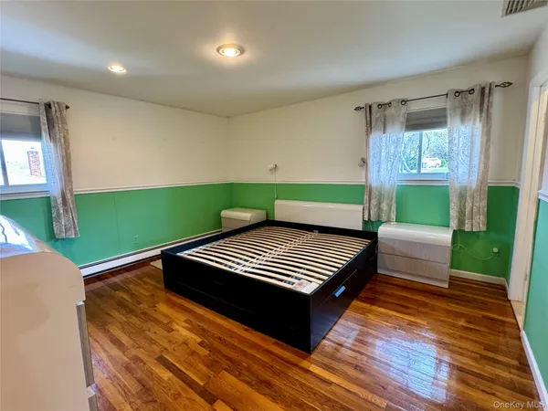 a view of room with wooden floor and stairs