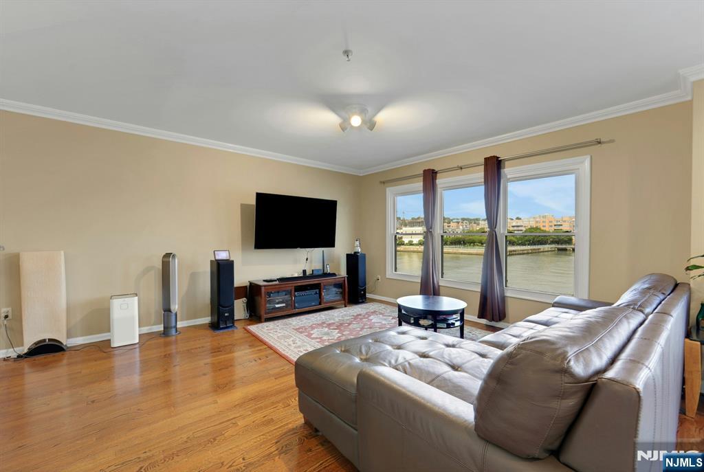 155 The Promenade Edgewater, NJ 07020 - Photo 12 of 31 a living room with furniture and a flat screen tv