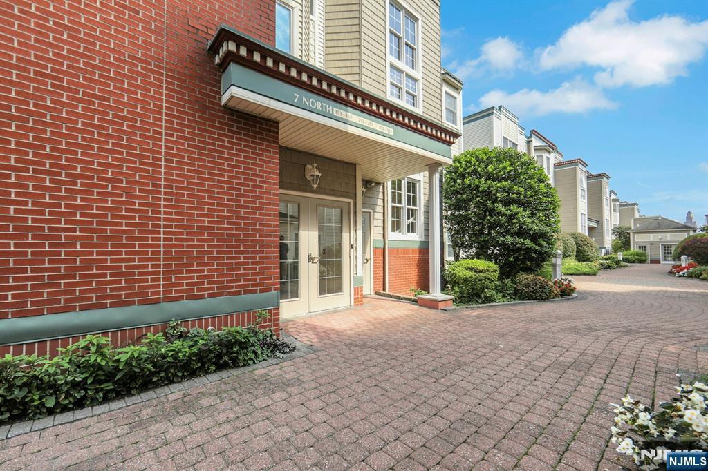 155 The Promenade Edgewater, NJ 07020 - Photo 2 of 31 a front view of a house with a yard