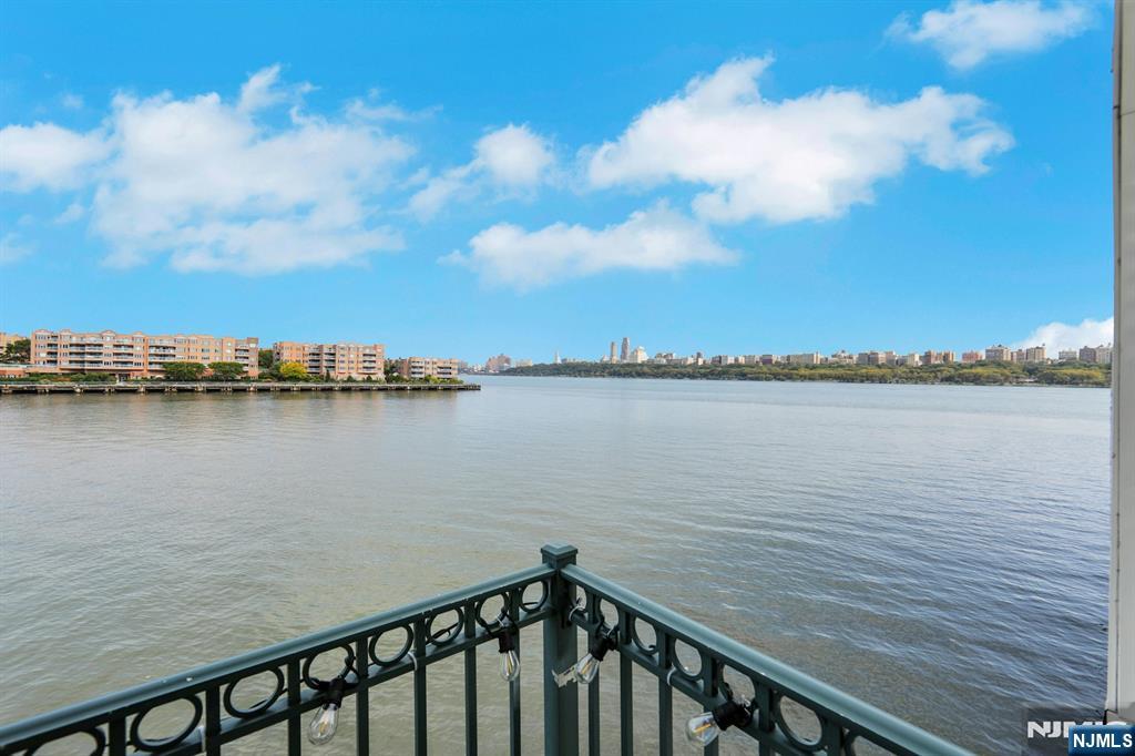 155 The Promenade Edgewater, NJ 07020 - Photo 27 of 31 a view of a lake from a balcony