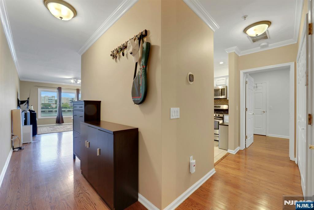 155 The Promenade Edgewater, NJ 07020 - Photo 8 of 31 a view of a hallway with wooden floor and staircase