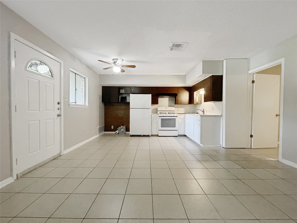 2503 Cecil Drive, Unit C Austin, TX 78744 - Photo 2 of 8 a view of a kitchen with white cabinets