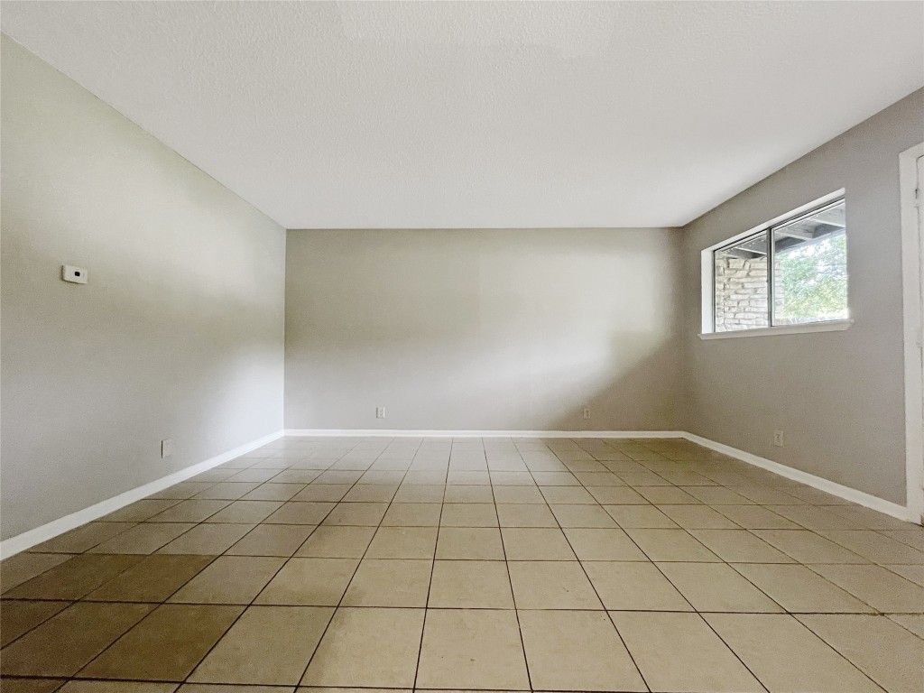 2503 Cecil Drive, Unit C Austin, TX 78744 - Photo 3 of 8 a view of an empty room and window