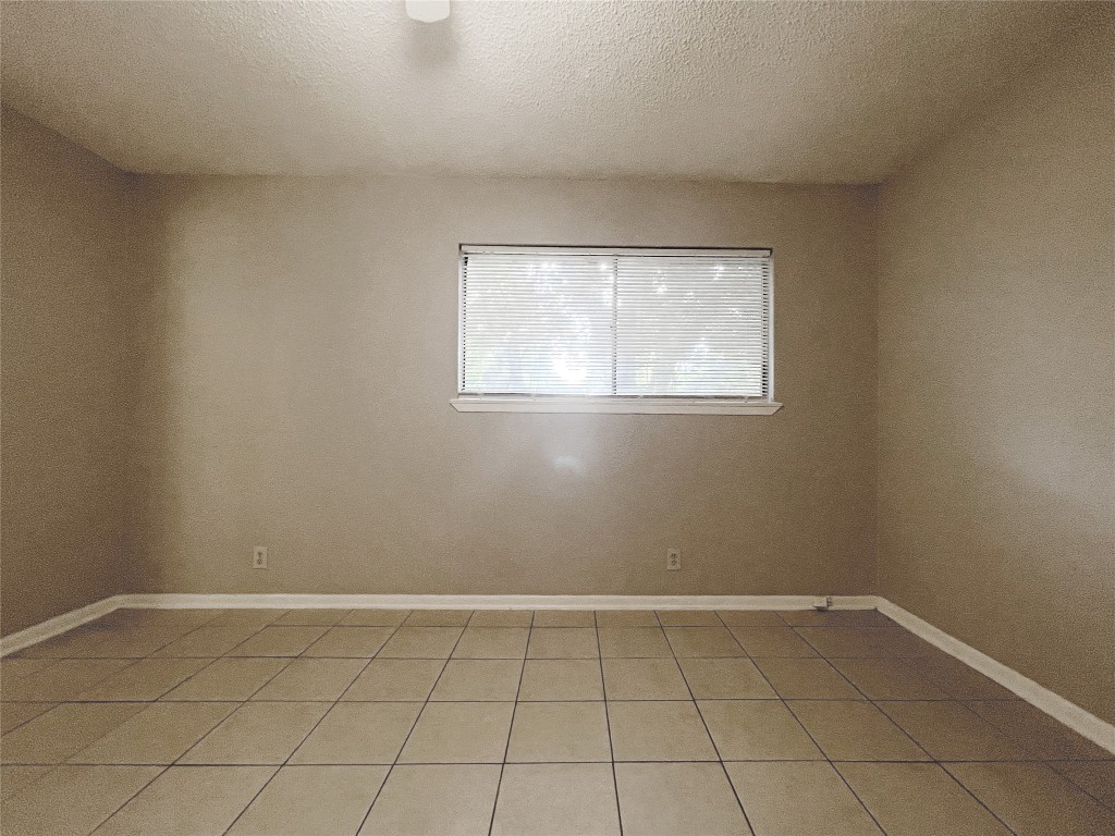 2503 Cecil Drive, Unit C Austin, TX 78744 - Photo 5 of 8 an empty room with a window