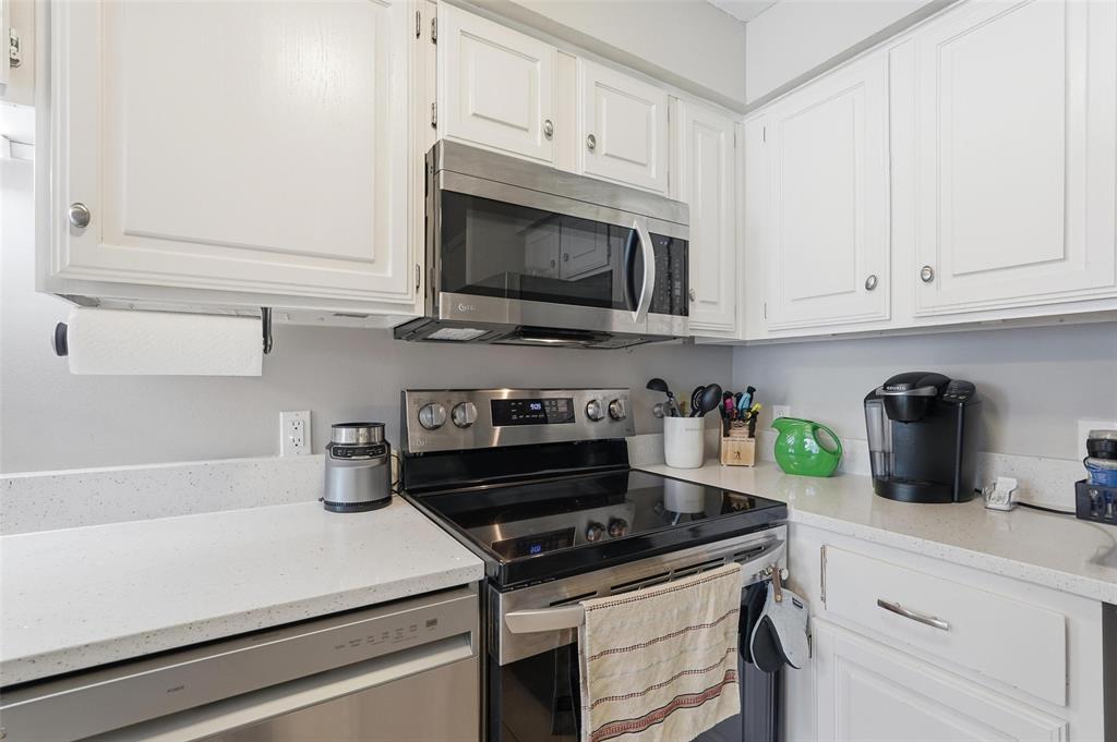 6220 Bentwood Trail, Unit 908 Dallas, TX 75252 - Photo 11 of 40 a kitchen with cabinets and appliances