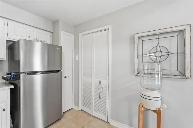 a metallic refrigerator freezer sitting in a kitchen