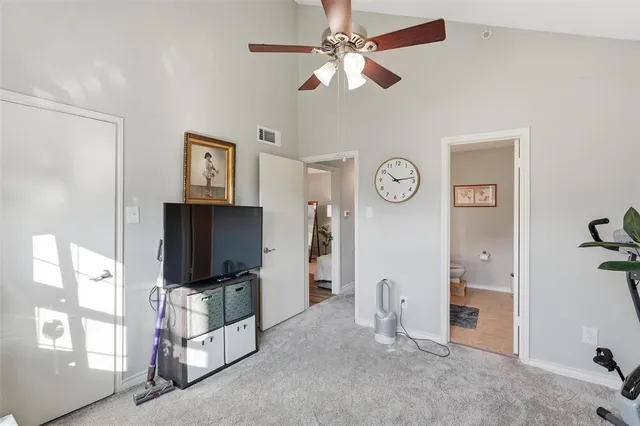a living room with furniture a flat screen tv and a window