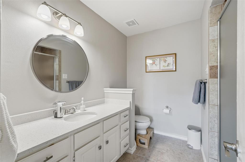 6220 Bentwood Trail, Unit 908 Dallas, TX 75252 - Photo 19 of 40 a bathroom with a toilet sink and mirror