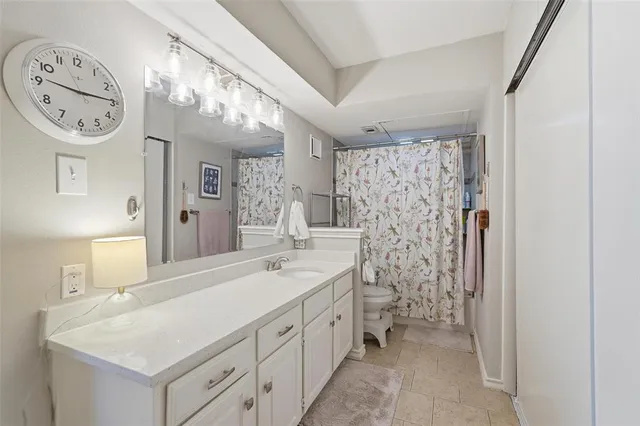 a bathroom with a double vanity sink mirror and shower