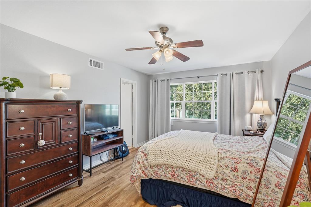 6220 Bentwood Trail, Unit 908 Dallas, TX 75252 - Photo 23 of 40 a bedroom with a bed a dresser and a window