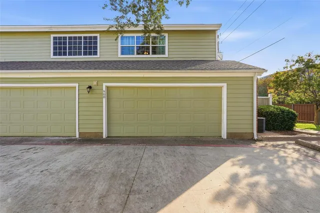 a view of a house with a yard and garage