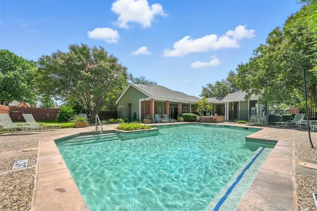 a front view of a house with swimming pool having outdoor seating