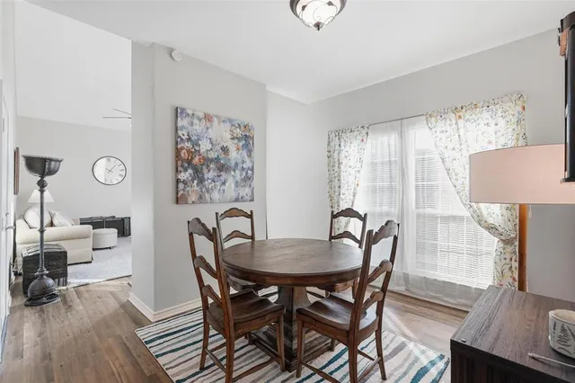 a dining room with furniture and wooden floor