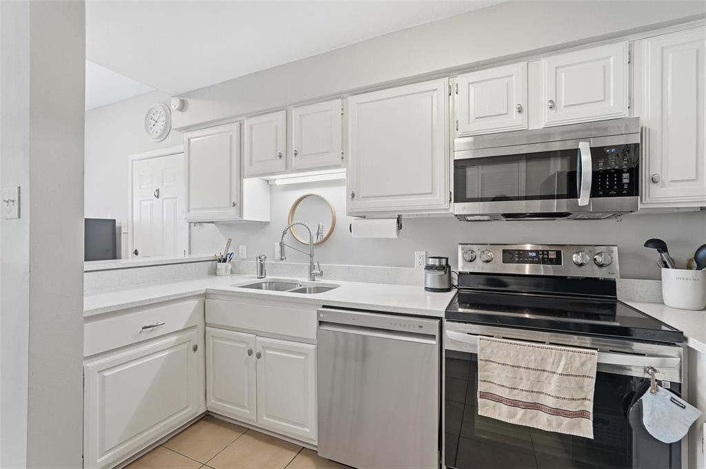 6220 Bentwood Trail, Unit 908 Dallas, TX 75252 - Photo 8 of 40 a kitchen with cabinets appliances a sink and a counter top