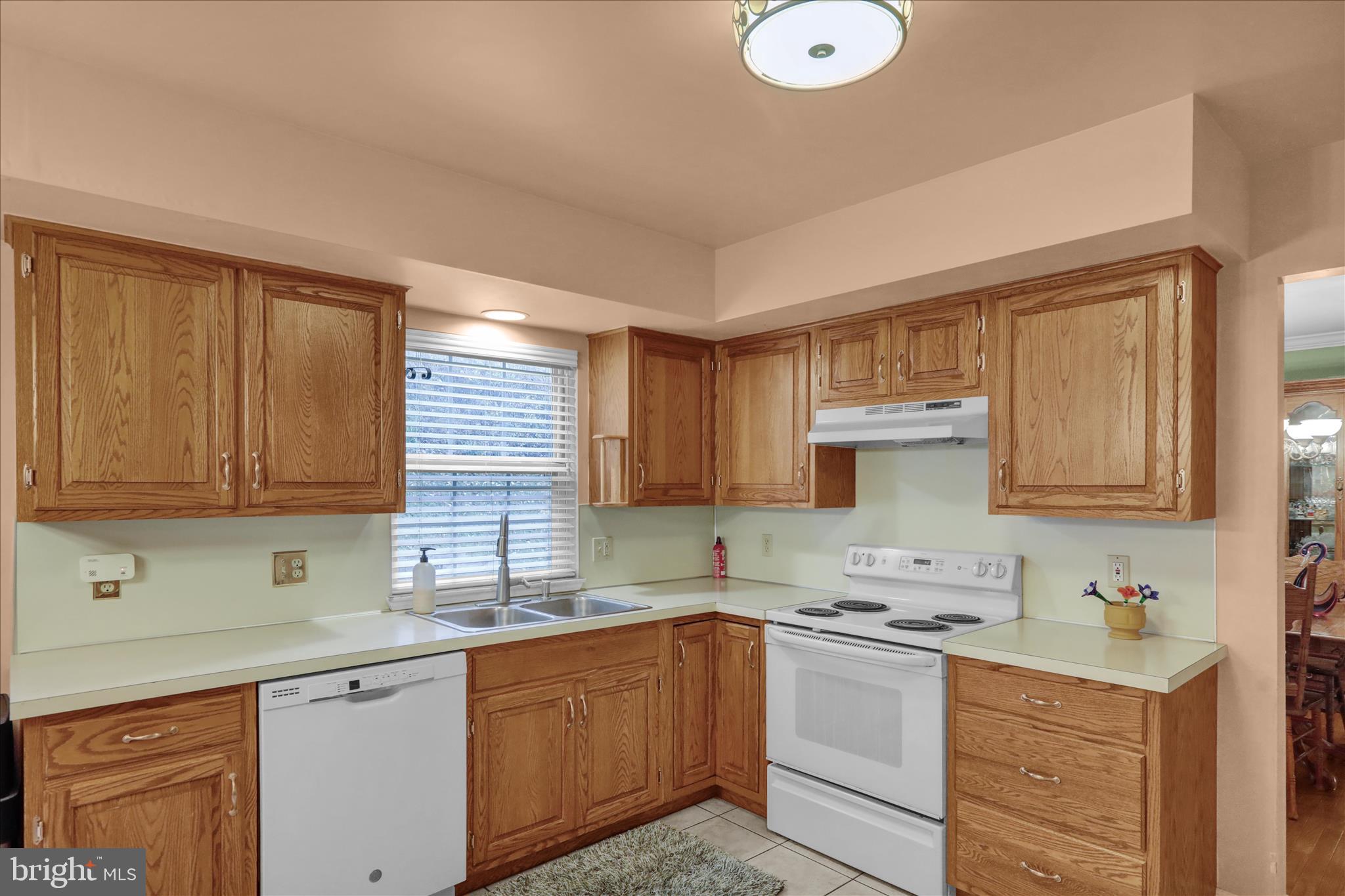1189 Cedar Top Road Reading, PA 19607 - Photo 12 of 38 a kitchen with granite countertop a sink cabinets stainless steel appliances and a window