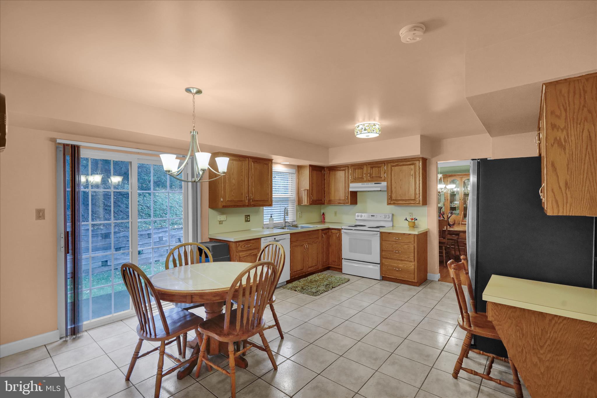 1189 Cedar Top Road Reading, PA 19607 - Photo 13 of 38 a dining area with a table chairs and a kitchen view