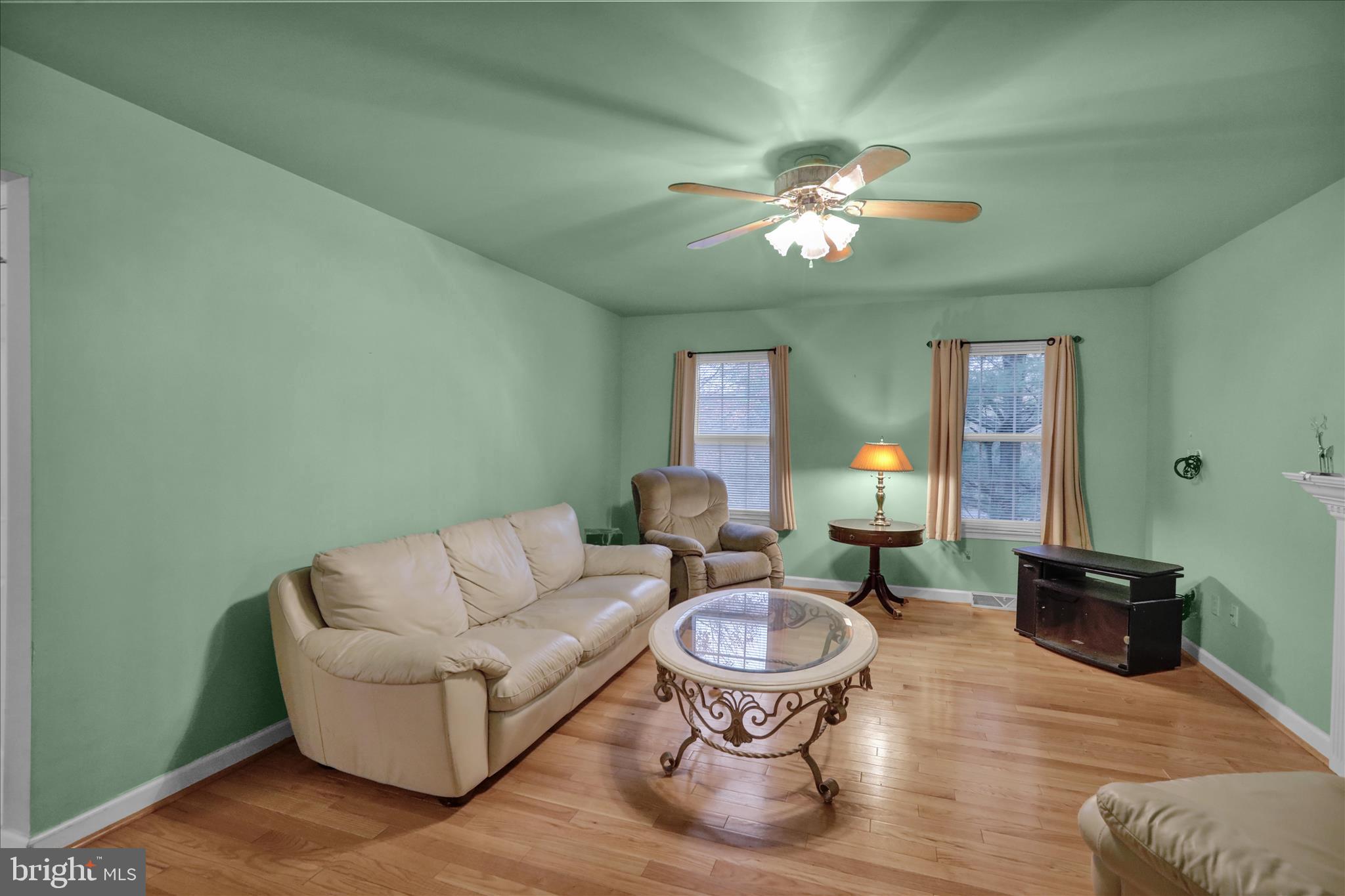 1189 Cedar Top Road Reading, PA 19607 - Photo 17 of 38 a living room with furniture a chandelier and a wooden floor
