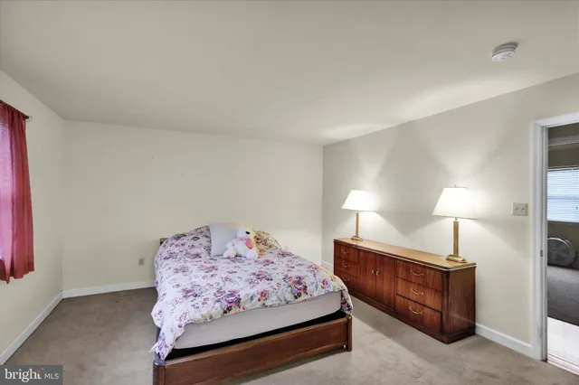 a bedroom with a bed and a lamp